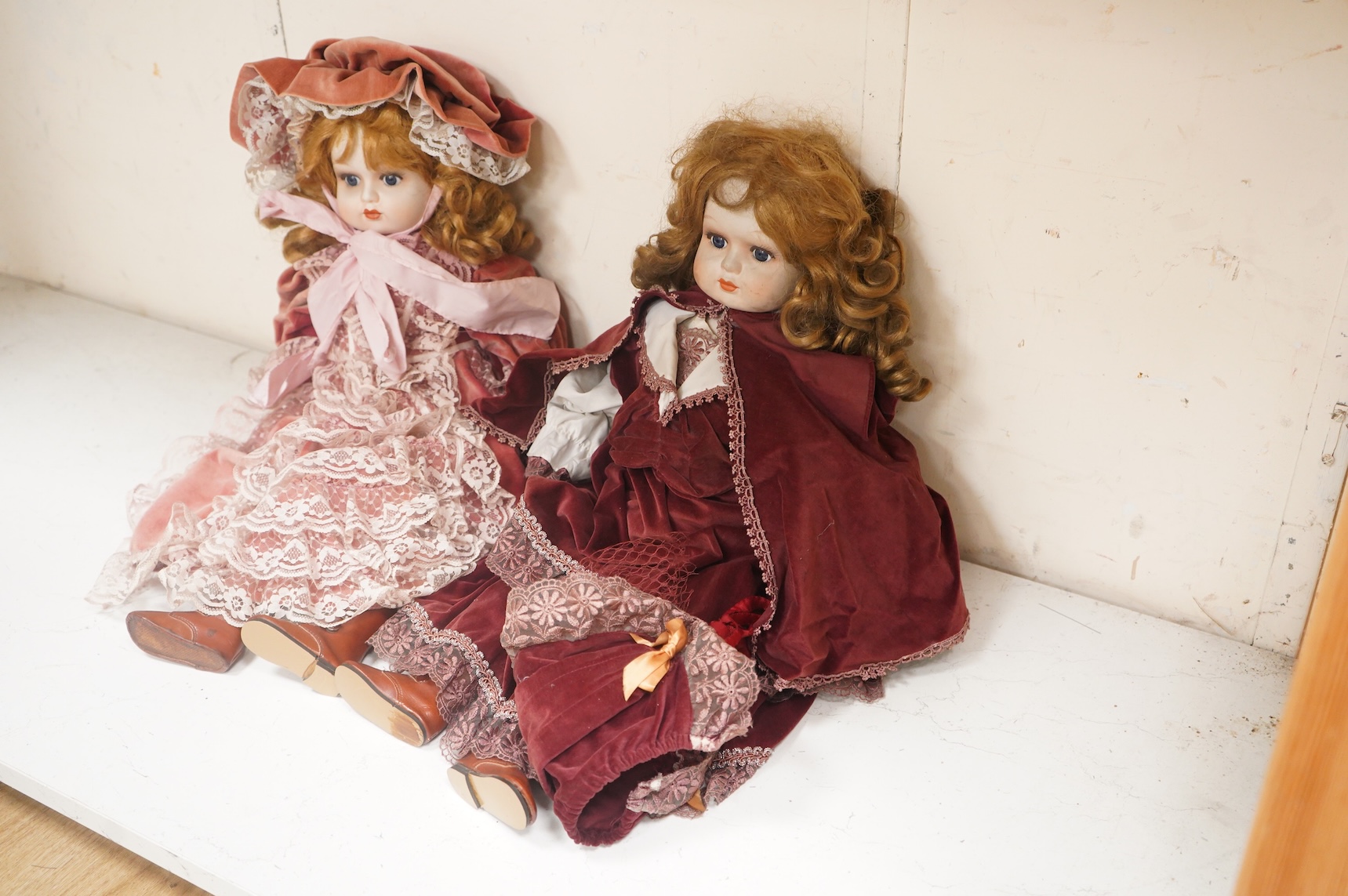 Two bisque dolls in matching Victorian clothing, 60cm high